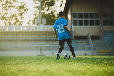 Man playing soccer ball on field