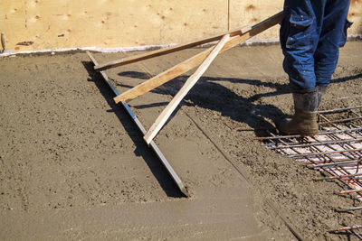 Low section of man working at construction site
