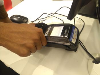 High angle view of person using smart phone on table