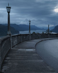 Street light by road against sky