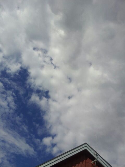 low angle view, sky, cloud - sky, cloudy, architecture, built structure, building exterior, high section, cloud, overcast, weather, outdoors, roof, house, day, nature, no people, building, cloudscape, residential structure