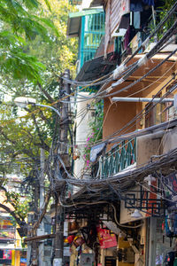 Low angle view of buildings and tree in city