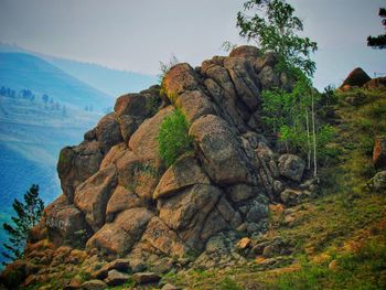 Rock formation on mountain against sky