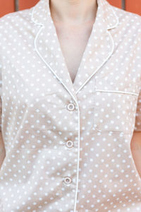 Midsection of woman standing against white background