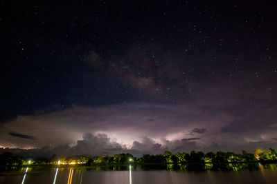 Scenic view of illuminated trees against sky at night