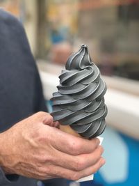 Close-up of hand holding ice cream cone