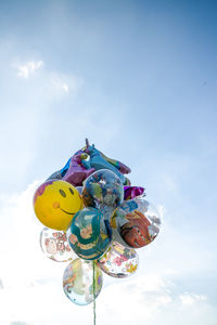 Low angle view of balloons toy against sky