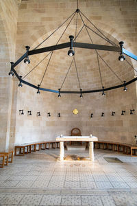 Low angle view of bench on ceiling of building church 