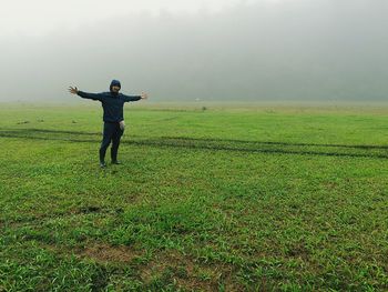 Full length of man standing on grass