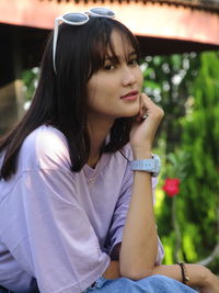 Portrait of young woman sitting outdoors