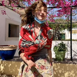 Young woman standing against plants