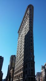 Low angle view of modern building against clear blue sky