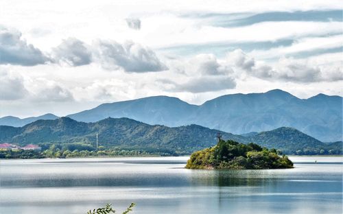 Scenic view of lake and mountains against sky