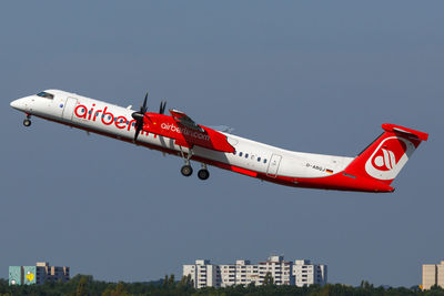 Red airplane flying in sky