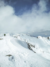 Scenic view of snow covered mountains against sky