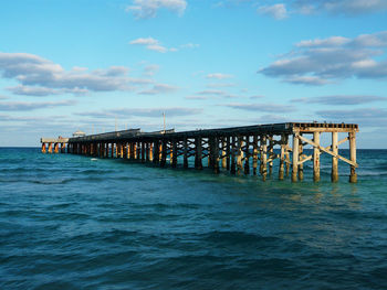 Pier over sea against sky