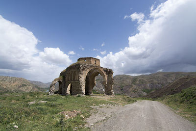 View of old ruins against cloudy sky