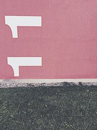 Close-up of road sign on wall