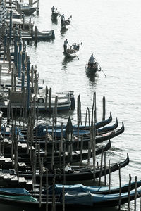 High angle view of wooden posts moored in sea