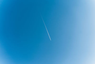 Low angle view of vapor trails in sky