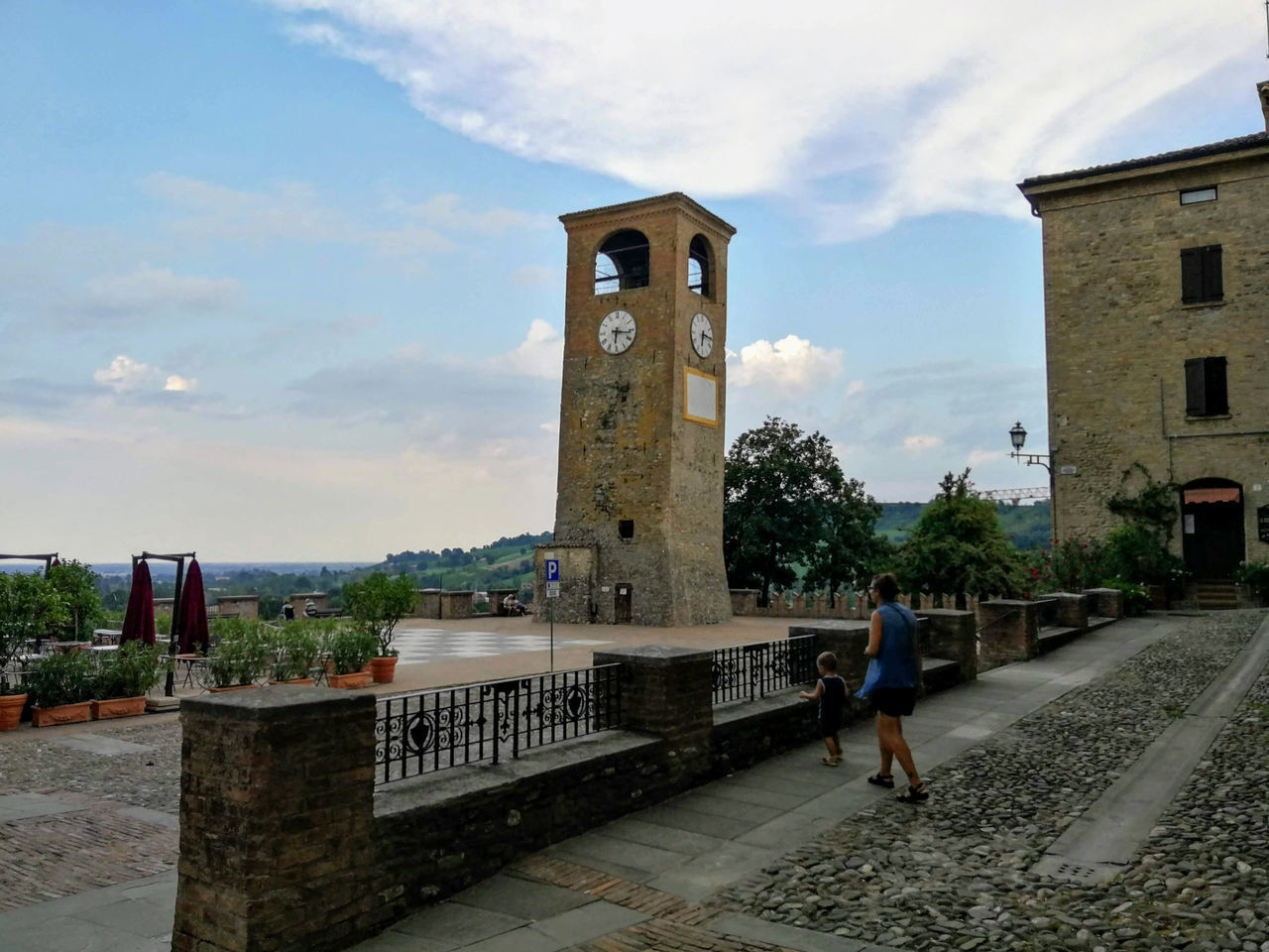 WOMAN WALKING ON HISTORIC BUILDING AGAINST SKY