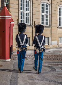 Two guards  guarding the royal palace official residence of the danish royal family in copenhagen