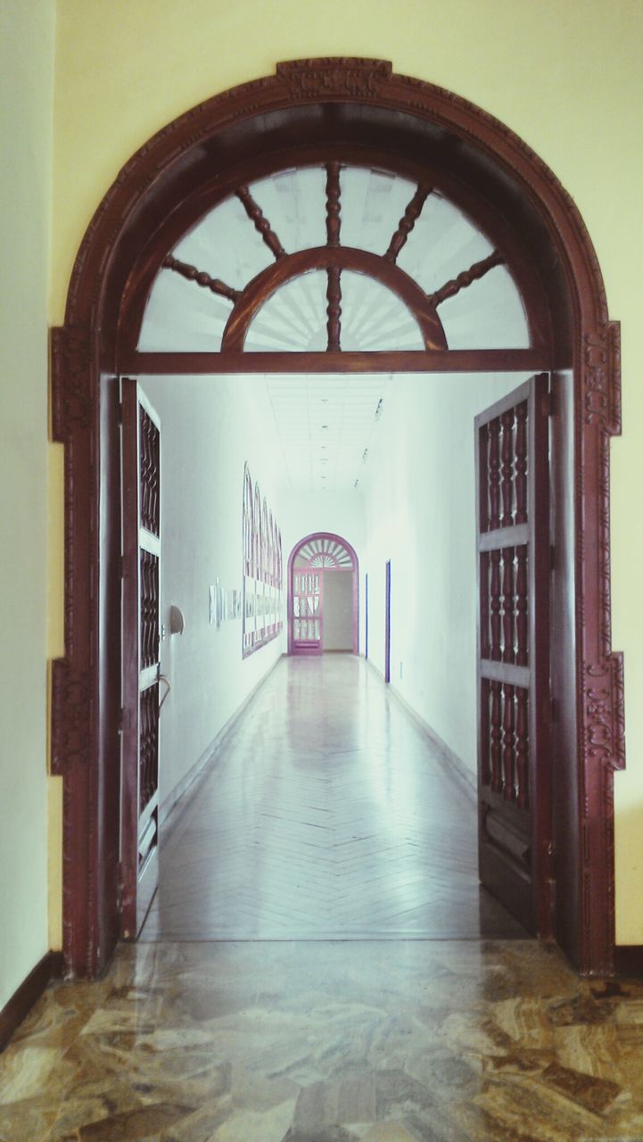 architecture, built structure, arch, indoors, door, entrance, building exterior, window, building, empty, corridor, closed, flooring, no people, day, wall - building feature, absence, doorway, the way forward, wall