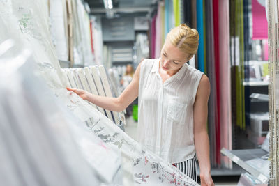 Woman looking away while standing at store