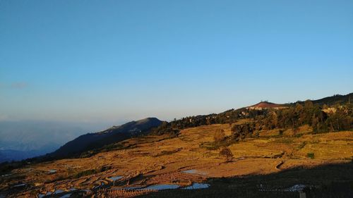 Scenic view of mountains against clear blue sky