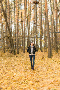 Rear view of woman standing in forest