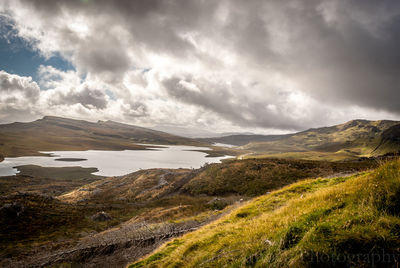 Scenic view of lake against cloudy sky