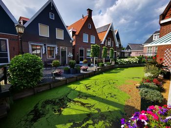 Scenic view of residential buildings in city against sky