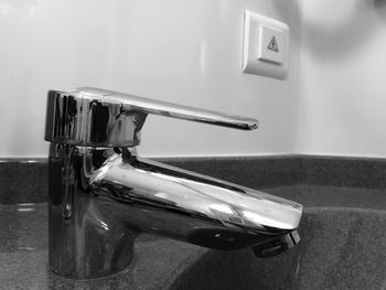 Close-up of faucet on bathroom sink at home