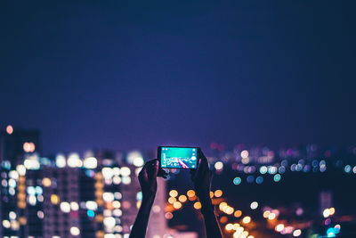 Illuminated city street at night