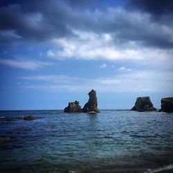 Scenic view of sea against cloudy sky