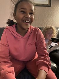 Portrait of smiling girl sitting at home