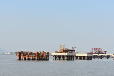 Panoramic view of pier on sea against clear sky