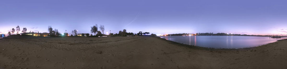Panoramic view of beach against sky at night