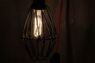 Close-up of illuminated light bulb in darkroom