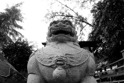 Low angle view of statue against trees