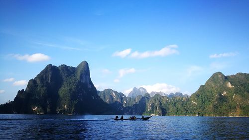 Scenic view of sea and mountains against sky