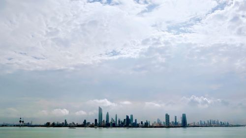 Panoramic view of sea and buildings against sky