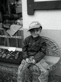 Portrait of smiling boy sitting outdoors