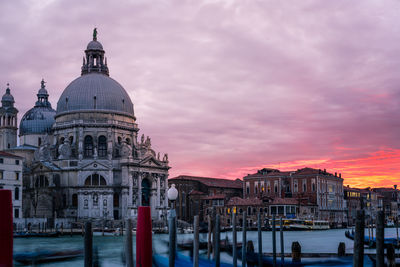 View of cathedral against cloudy sky in city during sunset