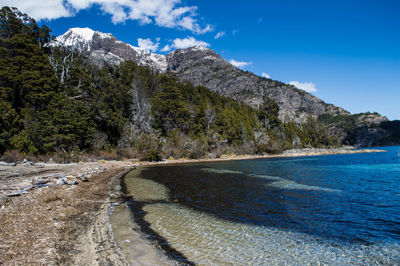 Scenic view of mountains against blue sky