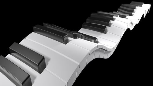 Close-up of piano over black background