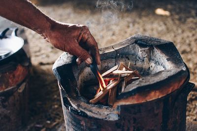 Close-up of hand igniting fire 