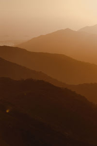 Scenic view of silhouette mountains against sky during sunset