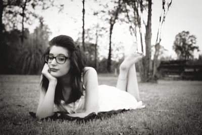 Portrait of woman sitting on field