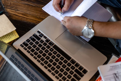 High angle view of man using laptop on table